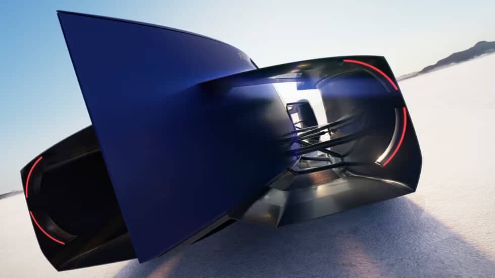 Vista trasera del Renault Filante Record 2025, un prototipo eléctrico de alta velocidad con aerodinámica extrema. La imagen muestra su diseño futurista con enormes conductos de aire y luces LED en forma de arco, optimizados para reducir la resistencia al viento. El coche está situado sobre una superficie desértica, evocando los récords de velocidad en Bonneville.